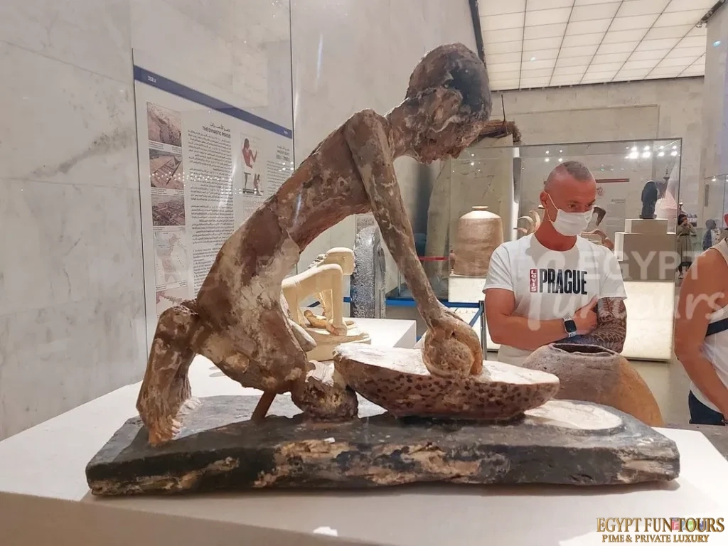 Grinding wheat man statue NMEC Egypt Fun Tours